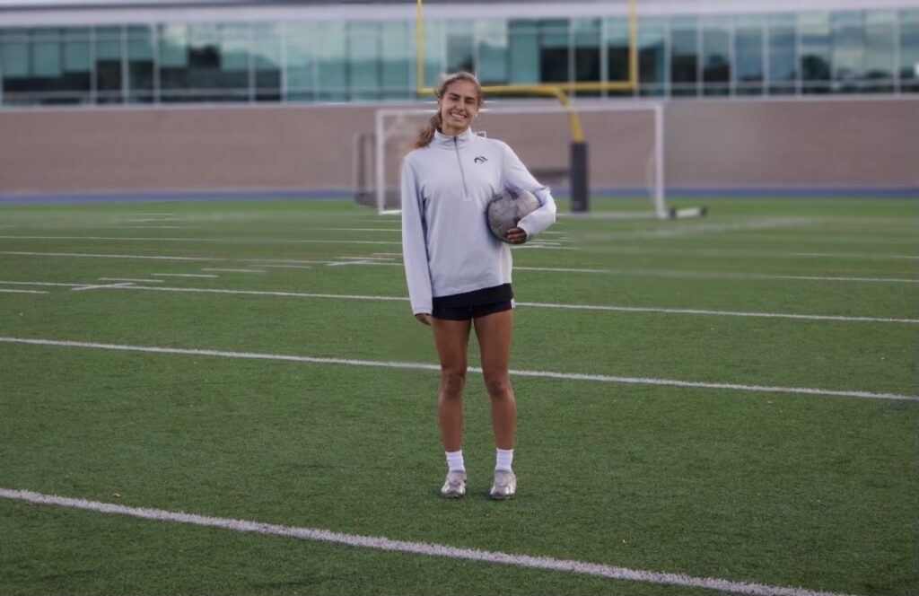 Raiya Rumo posing with soccer ball in hand on TCC field